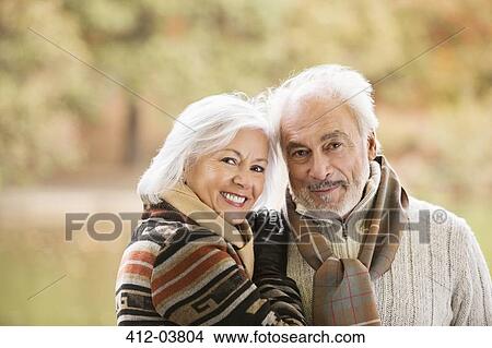 Older couple smiling together in park View Large Photo Image Picture - Older couple smiling together in park. Fotosearch