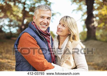 Older couple smiling together in park View Large Photo Image Stock Image - Older couple smiling together in park. Fotosearch