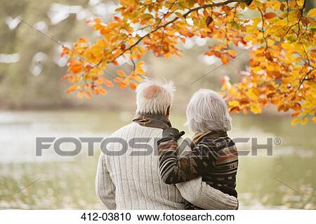 Older couple standing in park View Large Photo Image Stock Image - Older couple standing in park. Fotosearch