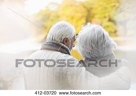Older couple standing together in park View Large Photo Image Stock Image - Older couple standing together in park. Fotosearch