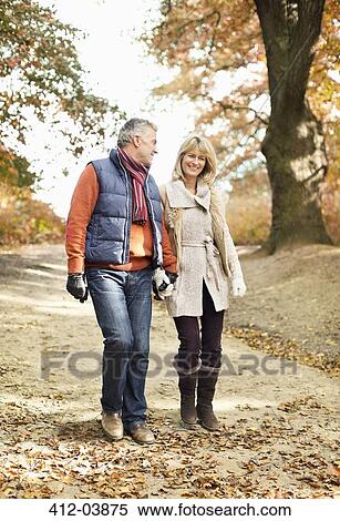 Stock Photography - Older couple walking in park. Fotosearch