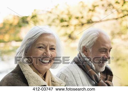 Stock Photo - Older couple walking together in park. Fotosearch