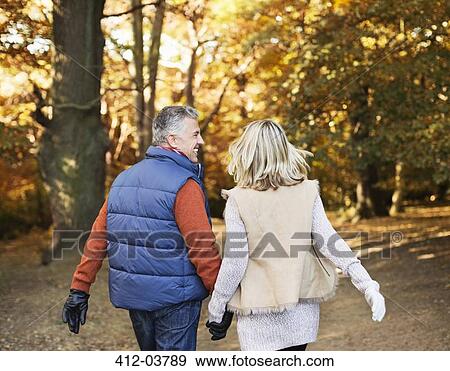 Stock Photo - Older couple walking together in park. Fotosearch
