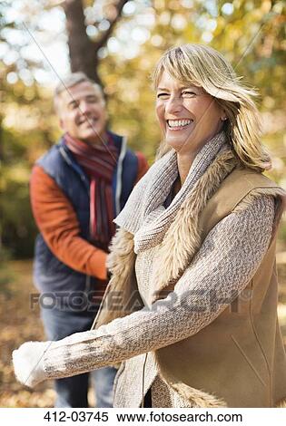 Stock Photography - Older couple walking together in park. Fotosearch