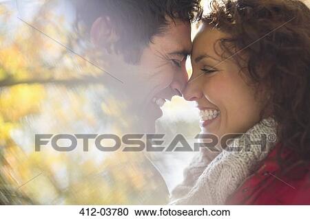 Smiling couple touching noses outdoors View Large Photo Image Stock Image - Smiling couple touching noses outdoors. Fotosearch