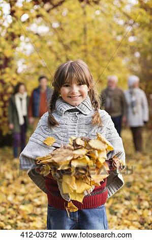Smiling girl playing in autumn leaves View Large Photo Image Stock Image - Smiling girl playing in autumn leaves. Fotosearch
