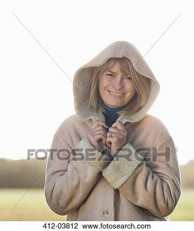 Smiling older woman standing outdoors View Large Photo Image Stock Image - Smiling older woman standing outdoors. Fotosearch