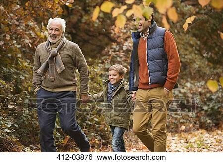 Stock Photograph - Three generations of men walking in park. Fotosearch