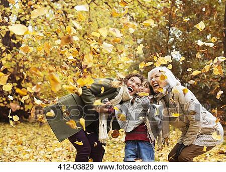Three generations of women playing in autumn leaves View Large Photo Image Stock Photo - Three generations of women playing in autumn leaves. Fotosearch