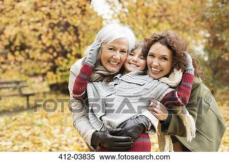 Three generations of women smiling in park View Large Photo Image Stock Photography - Three generations of women smiling in park. Fotosearch