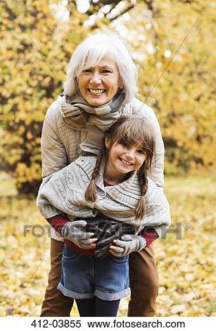 Woman and granddaughter hugging in park View Large Photo Image Stock Photography - Woman and granddaughter hugging in park. Fotosearch