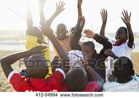Boys cheering together in dirt field View Large Photo Image Picture - Boys cheering together in dirt field. Fotosearch