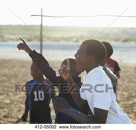 Boys shouting together in dirt field View Large Photo Image Stock Image - Boys shouting together in dirt field. Fotosearch