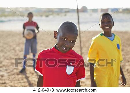 Boys smiling in dirt field View Large Photo Image Stock Image - Boys smiling in dirt field. Fotosearch