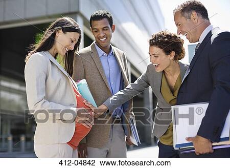 Business people admiring pregnant colleague's bell View Large Photo Image Stock Image - Business people admiring pregnant colleague's bell. Fotosearch