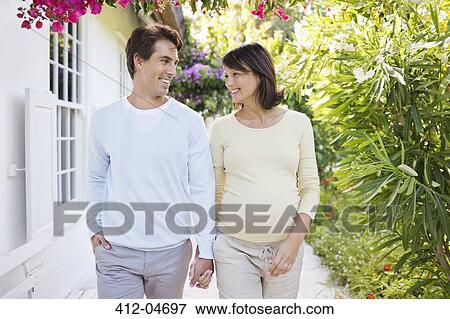 Stock Photo - Couple holding hands outdoors. Fotosearch
