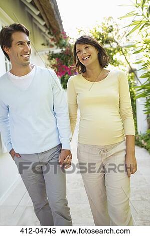 Couple walking together outdoors View Large Photo Image Stock Photography - Couple walking together outdoors. Fotosearch