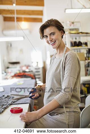 Dressmaker cutting fabric in studio View Large Photo Image Stock Image - Dressmaker cutting fabric in studio. Fotosearch