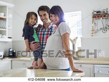 Family smiling together in kitchen View Large Photo Image Stock Photo - Family smiling together in kitchen. Fotosearch