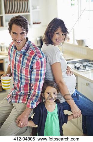 Family smiling together in kitchen View Large Photo Image Stock Photography - Family smiling together in kitchen. Fotosearch