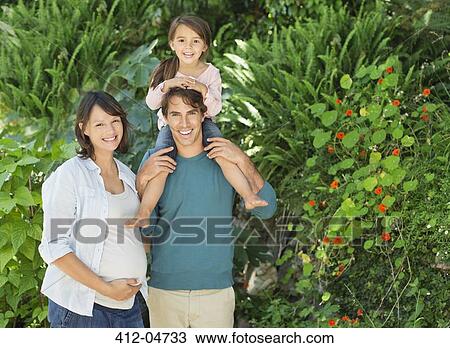 Stock Image - Family smiling together outdoors. Fotosearch