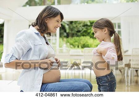 Girl and pregnant mother comparing bellies View Large Photo Image Stock Image - Girl and pregnant mother comparing bellies. Fotosearch