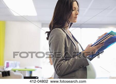 Pregnant businesswoman working in office View Large Photo Image Stock Image - Pregnant businesswoman working in office. Fotosearch