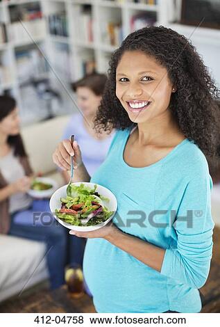 Pregnant woman eating salad View Large Photo Image Stock Photo - Pregnant woman eating salad. Fotosearch
