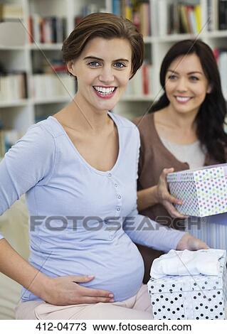 Stock Image - Pregnant woman having baby shower. Fotosearch