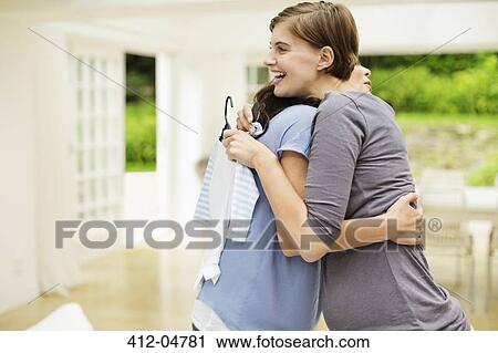 Stock Image - Pregnant woman having baby shower. Fotosearch