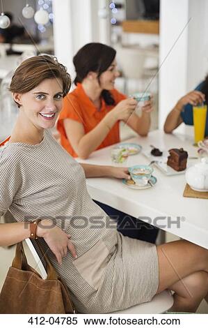 Pregnant woman having cup of coffee with friends View Large Photo Image Stock Photography - Pregnant woman having cup of coffee with friends. Fotosearch