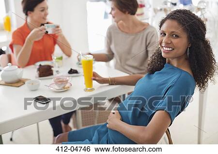 Pregnant woman having glass of juice View Large Photo Image Stock Photograph - Pregnant woman having glass of juice. Fotosearch