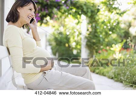 Pregnant woman talking on cell phone View Large Photo Image Stock Photograph - Pregnant woman talking on cell phone. Fotosearch