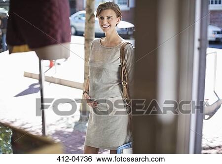 Pregnant woman window shopping on city street View Large Photo Image Stock Photograph - Pregnant woman window shopping on city street. Fotosearch