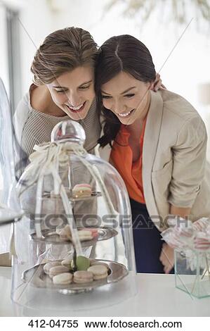 Women admiring tray of cookies View Large Photo Image Stock Photography - Women admiring tray of cookies. Fotosearch