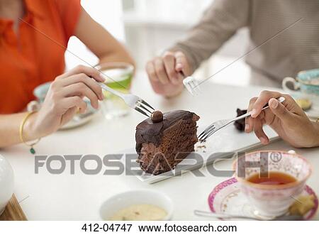 Women sharing slice of cake View Large Photo Image Stock Photo - Women sharing slice of cake. Fotosearch