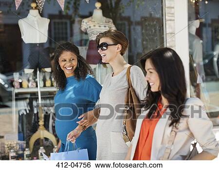 Stock Photograph - Women shopping together on city street. Fotosearch