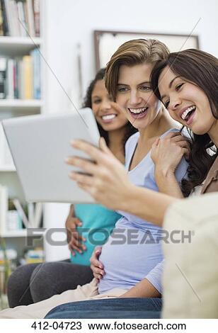 Women using tablet computer together View Large Photo Image Stock Image - Women using tablet computer together. Fotosearch