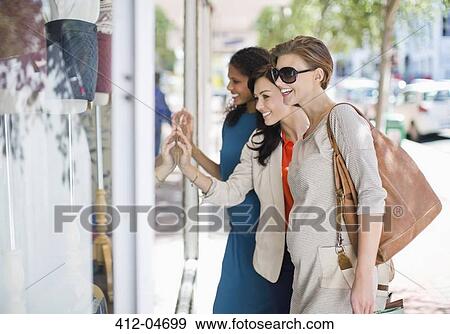 Stock Photo - Women window shopping on city street. Fotosearch