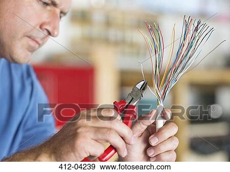 Electrician trimming wires View Large Photo Image Stock Photo - Electrician trimming wires. Fotosearch