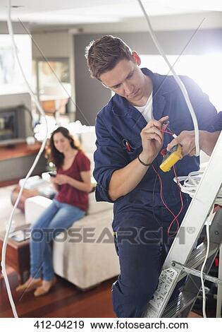 Electrician working in home View Large Photo Image Stock Photo - Electrician working in home. Fotosearch