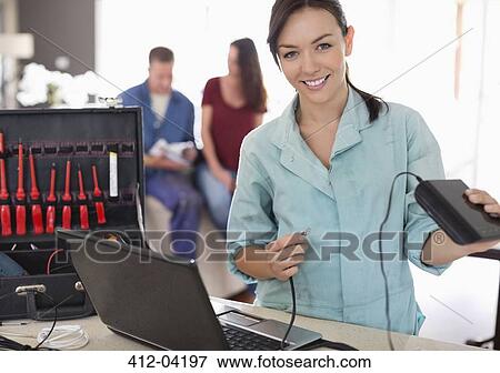 Female electrician using laptop in home View Large Photo Image Stock Photo - Female electrician using laptop in home. Fotosearch