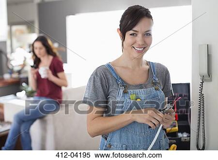 Female electrician working on telephone in home View Large Photo Image Stock Photography - Female electrician working on telephone in home. Fotosearch