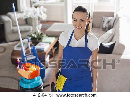Maid smiling in living room View Large Photo Image Stock Image - Maid smiling in living room. Fotosearch