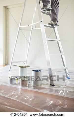 Man climbing ladder to paint room View Large Photo Image Picture - Man climbing ladder to paint room. Fotosearch