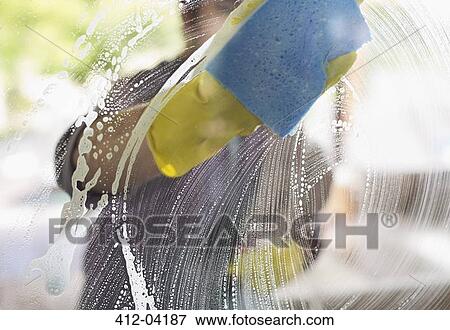 Man washing window with sponge View Large Photo Image Stock Photo - Man washing window with sponge. Fotosearch