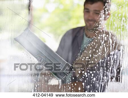 Man washing windows with squeegee View Large Photo Image Stock Photo - Man washing windows with squeegee. Fotosearch