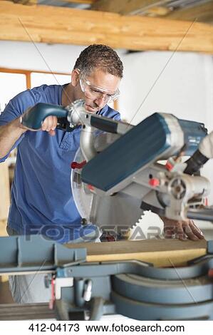 Man working in workshop View Large Photo Image Stock Image - Man working in workshop. Fotosearch