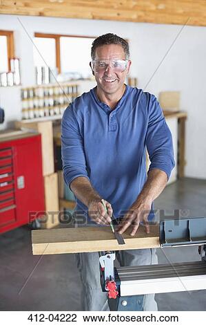 Man working in workshop View Large Photo Image Stock Image - Man working in workshop. Fotosearch