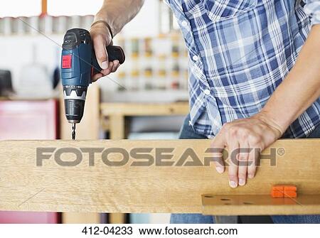 Man working in workshop View Large Photo Image Stock Image - Man working in workshop. Fotosearch